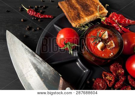 Tomato Soup With Chili And Vegetables. Healthy Food. On A Black Wooden Background. Top View. Copy Sp