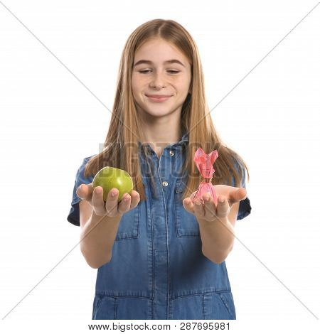 Teen Girl With Apple And Candy On White Background. Diabetes Diet