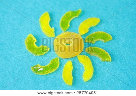 The Sun From Yellow Marmalade With Rays On A Light Blue Background Of Felt. Sugar Sweet Christmas Sw