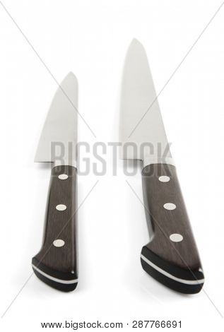 Two kitchen knives on white background isolated with shadows