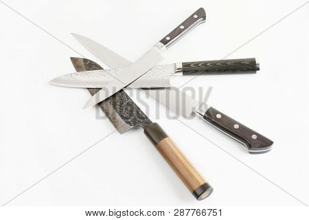Four different knives on light gray surface