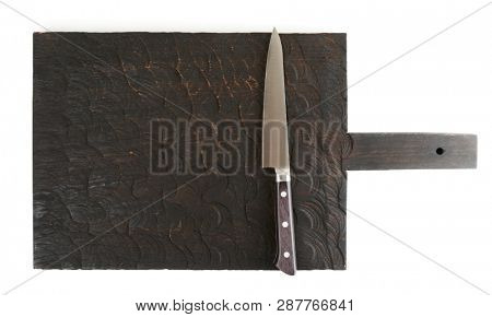 Utility knife on wooden board, isolated on white background