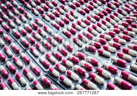 Pink-white Antibiotic Capsule Pills In Blister Pack. Antibiotics Drug Resistance. Pharmaceutical Pac