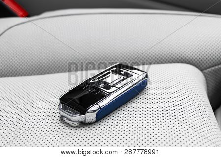 Closeup Inside Vehicle Of Wireless Blue Leather Key Ignition On White Leather Seat. Wireless Start E