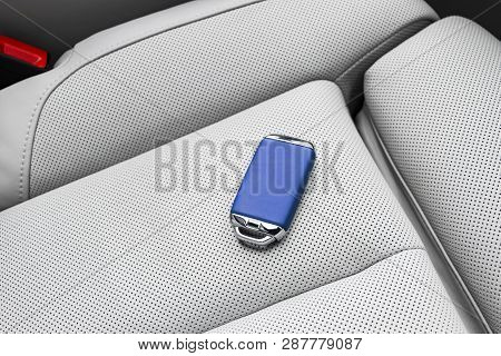 Closeup Inside Vehicle Of Wireless Blue Leather Key Ignition On White Leather Seat. Wireless Start E