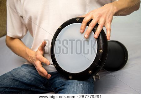 A Man Plays The Ethnic Drum. Close-up.