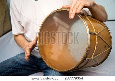 A Man Plays The Ethnic Drum. Close-up.