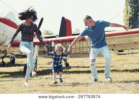 Lets Start Our Journey. Travelling By Air. Family On Vacation Trip. Couple With Boy Child At Plane. 