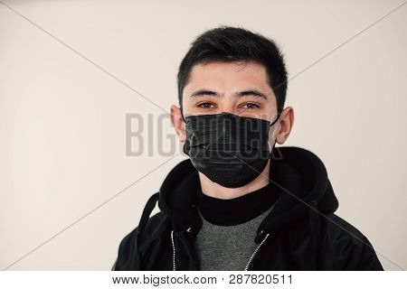 Guy In Black Clothes With A Black Mask On His Face