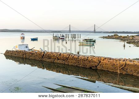 Boats And Bridge Over Guadiana River Which Is A Border Between Spain And Portugal.