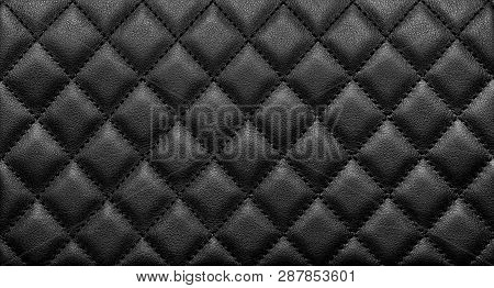 Close-up Texture Of Genuine Leather With Black Rhombic Stitching. Luxury Background