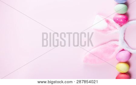 Easter Rabbit Flaffy Ears And Colored Easter Colored Eggs On Pink Background Banner With Copy Space