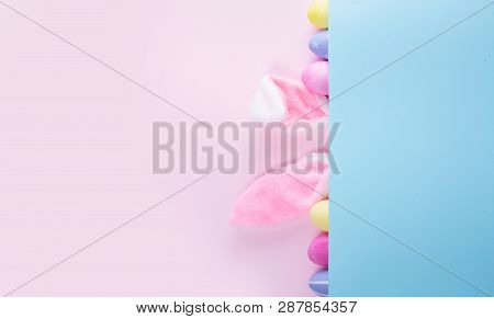 Easter Rabbit Flaffy Ears And Colored Easter Colored Eggs On Pink And Blue Background Banner With Co