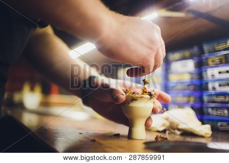 A Man Prepare Hookah Sisha In Hookah Art Bar. Tabaco Preparation.