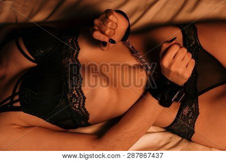 Slender Girl Sexy Lying On The Bed In Handcuffs For Bdsm Sex