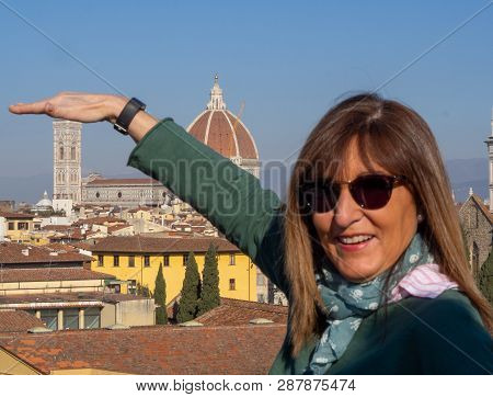 Mature And Beautiful Woman Poses On A Terrace And In Front Of The Florentine Cathedral, Santa Maria 
