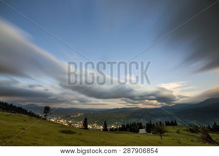 Summer Night Mountain Panorama. Green Grassy Mountain Clearing, Spruce Trees On Blue Evening Sky Cop