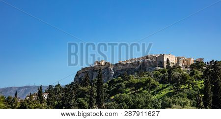 Acropolis Of Athens Greece Rock And Parthenon On Blue Sky Background, Sunny Day.