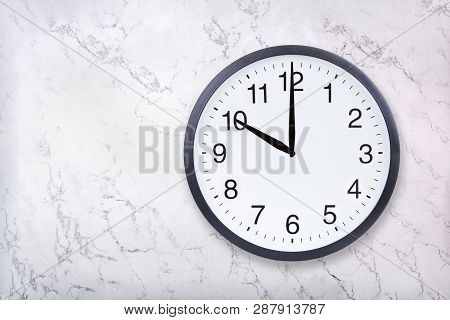 Wall Clock Show Ten Oclock On White Marble Texture. Office Clock Show 10pm Or 10am