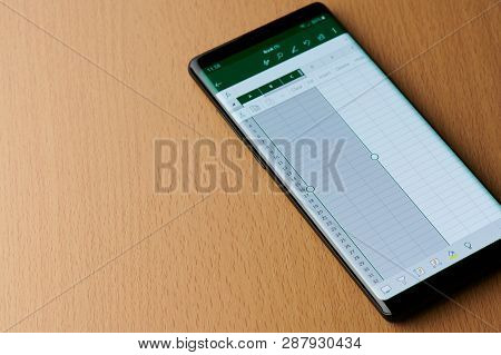 New York, Usa - March 6, 2019: Microsoft Office Excel Grid On Smartphone Screen Laying On Wooden Des