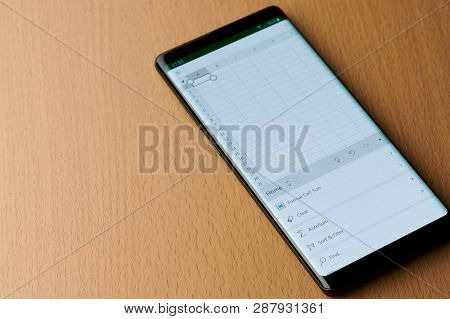 New York, Usa - March 6, 2019: Working In Microsoft Excel Application On Smartphone Screen Laying On