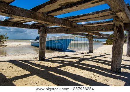 An Old Blue Boat On The Beach