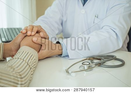 Friendly Man Doctor Hands Holding Patient Hand Sitting At The Desk For Encouragement, Empathy, Cheer