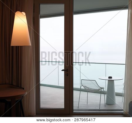 Living room with glass door to balcony. Sea view.