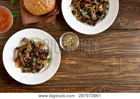 Cooked Fried Beef Liver With Onion On Plate Over Wooden Background. Pieces Cooked Liver (offal) From