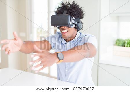 African amaerican man having fun playing with virtual reality glasses