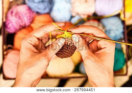 Ladies Hands With Crochet. Colored Yarn Background