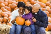 Family Holding Pumpkins.