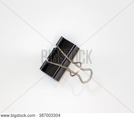 Clip For Papers. Binding Of Papers, Office Supplies. Binder For Papers On A White Background