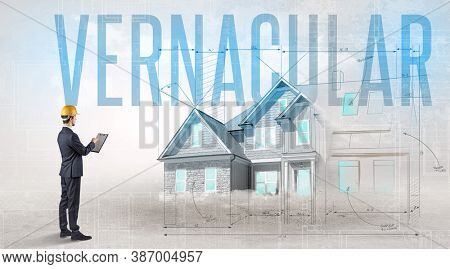 Young engineer holding blueprint with VERNACULAR inscription, house planning concept