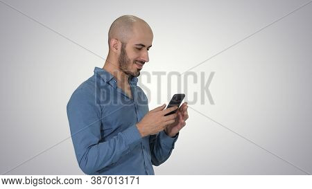 Casual Arabic Businessman Using The Phone And Smiling On Gradien