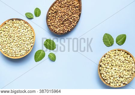 Green Buckwheat, Sprouted Buckwheat In Wooden Bowls Brown Buckwheat Grains In Wooden Spoon With Gree