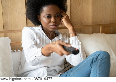 Bored Black Woman Lying At Home Sofa Couch, Watching Television Looking Tired And Bored Disappointed