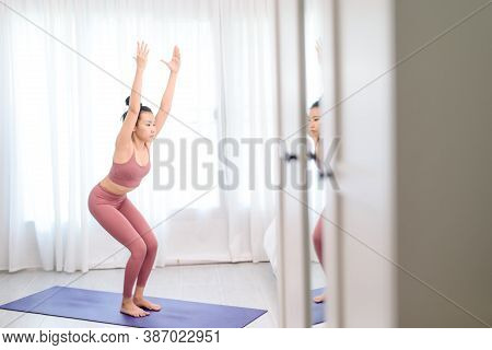 Young Woman Do Yoga In A Bed Room