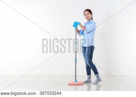 Beautiful Asian Woman In Protective Gloves And Holding A Mop For Cleaning Floor.