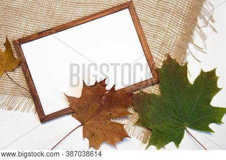 Top View Flat Lay Autumn Composition. Blank Brown Frame, Dried Barbed Plants, Straw Work And Sackclo