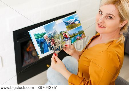 Close-up Of Woman Looking Through Photo Album, Photobook