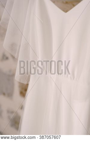 Close-up Of The Fabric Of The Brides White Wedding Dress.
