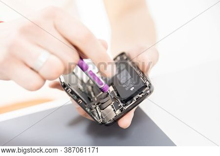 Russia - July 27, 2020: Repair Iphone Apple Broken Phone Screen And Replace Used Rechargeable Batter