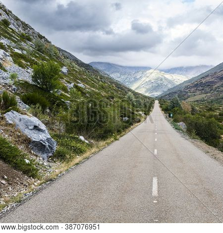 Stright Asphalt Road Of Europe Peaks In Spain On A Rainy Day