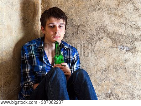 Sad Young Man In Alcohol Addiction With A Beer