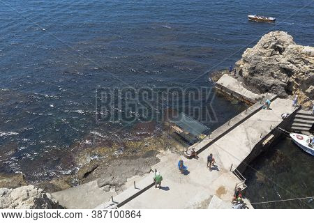 Chernomorsky District, Crimea, Russia - July 21, 2020: Concrete Pier With Tourists At The Bolshoi At