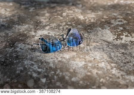 Arkhyz, Russia - September 19, 2020: Ray-ban Aviators Glasses On A Stone Wall. Popular Brand Of Sung