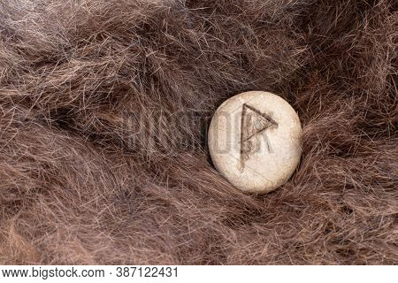 Wunjo Nordic Stone Rune On Animal Fur. Letter Wyn Of The Viking Alphabet.