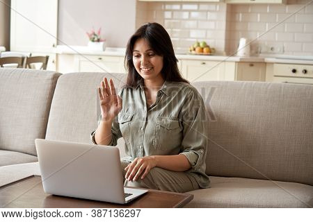 Smiling Young Indian Woman Video Calling Using Laptop Webcam Conference Work At Home Office. Happy L
