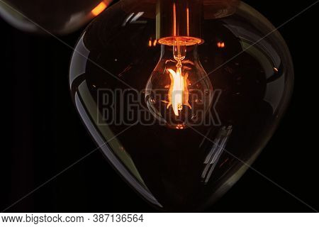 Light Bulb Shining In Transparent Glass Globe In The Dark
